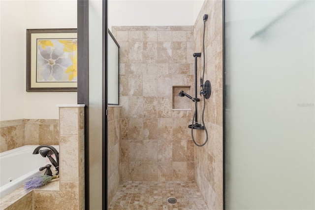 bathroom with a garden tub and a stall shower