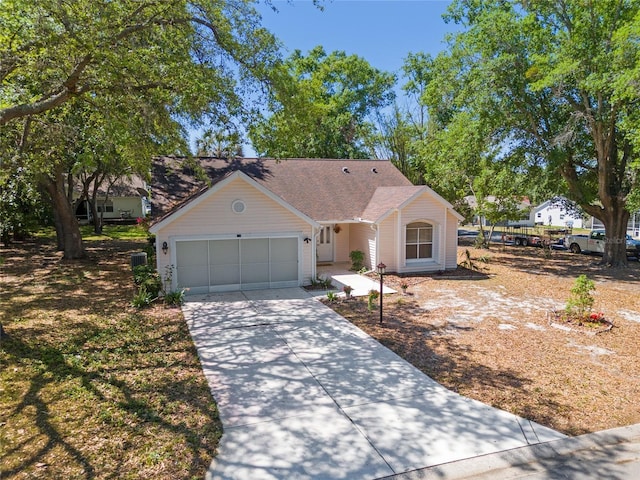 ranch-style home with central AC, driveway, and a garage