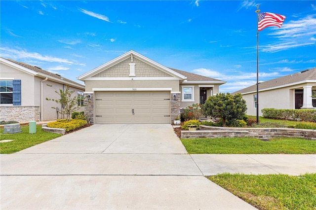 5220 Sunshine Dr, Wildwood, FL 34785 - view of front of property with driveway, stucco siding, stone siding, and an attached garage