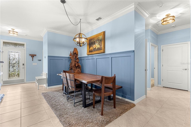 5220 Sunshine Dr, Wildwood, FL 34785 - dining area featuring ornamental molding, visible vents, a wainscoted wall, tile patterned floors, and a notable chandelier