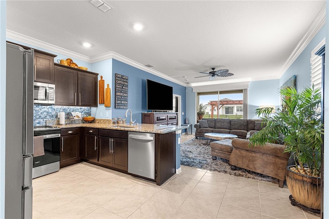 5220 Sunshine Dr, Wildwood, FL 34785 - kitchen with visible vents, a sink, open floor plan, dark brown cabinetry, and stainless steel appliances