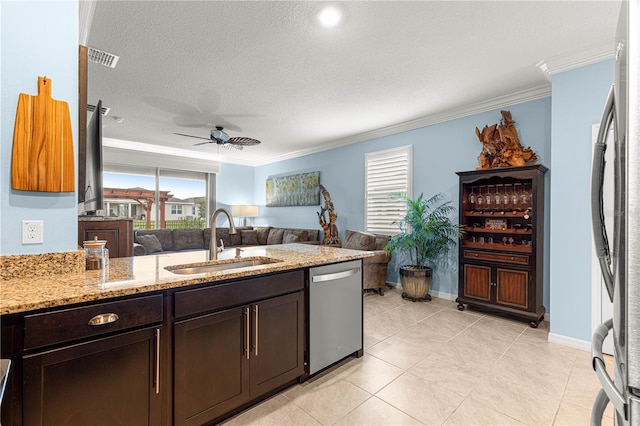 5220 Sunshine Dr, Wildwood, FL 34785 - kitchen with a sink, appliances with stainless steel finishes, light stone counters, and a healthy amount of sunlight