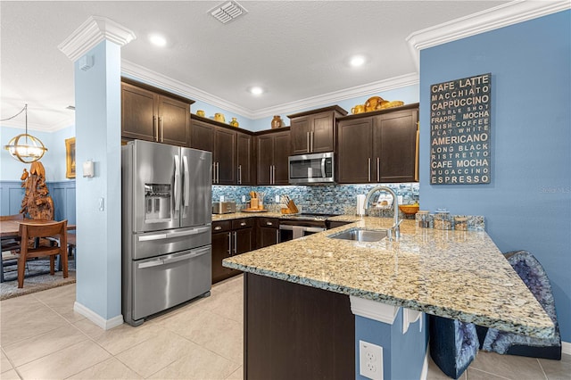 5220 Sunshine Dr, Wildwood, FL 34785 - kitchen with a peninsula, dark brown cabinets, visible vents, stainless steel appliances, and a sink
