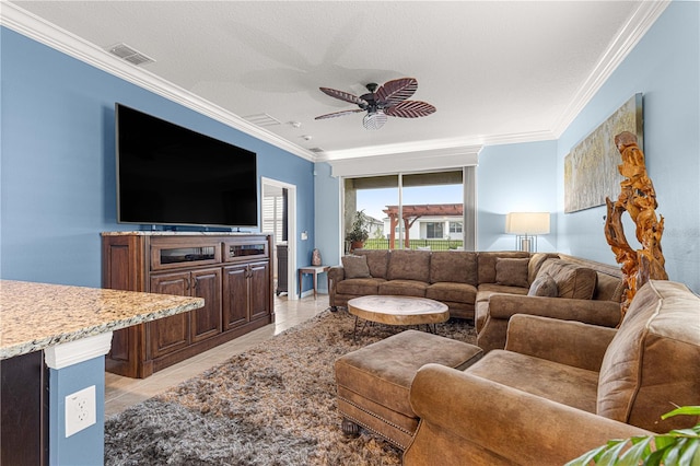 5220 Sunshine Dr, Wildwood, FL 34785 - living room with visible vents, light tile patterned floors, ceiling fan, a textured ceiling, and crown molding