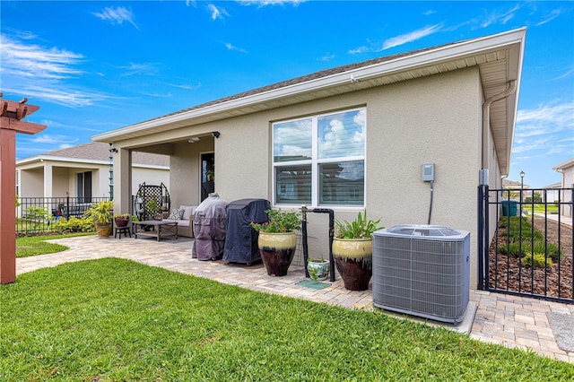 5220 Sunshine Dr, Wildwood, FL 34785 - back of house with central AC unit, a patio area, a lawn, fence, and stucco siding
