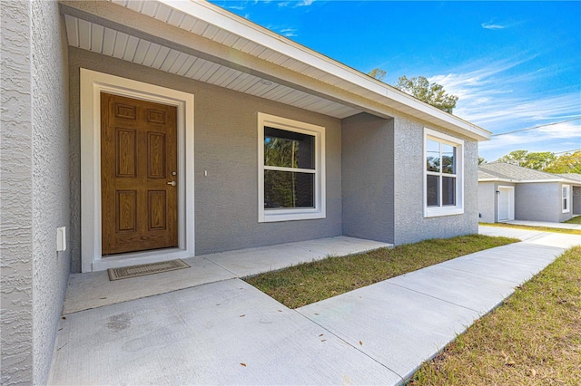 doorway to property with stucco siding