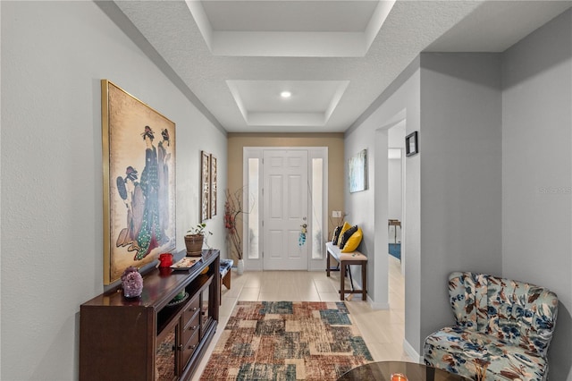 foyer featuring a raised ceiling