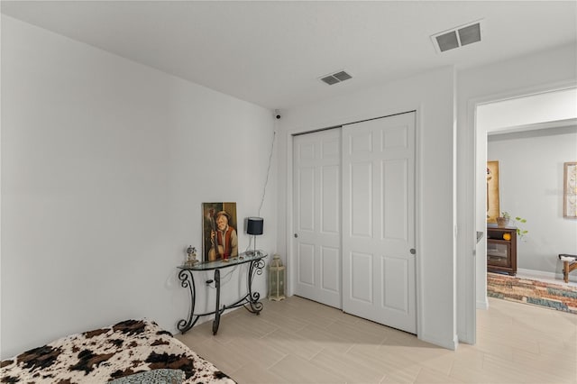bedroom with a closet and visible vents