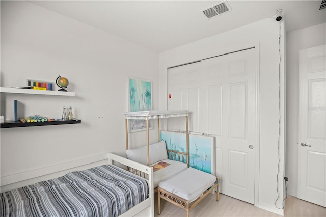 bedroom with visible vents and a closet