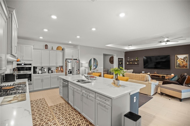 kitchen featuring a sink, a ceiling fan, recessed lighting, stainless steel appliances, and backsplash
