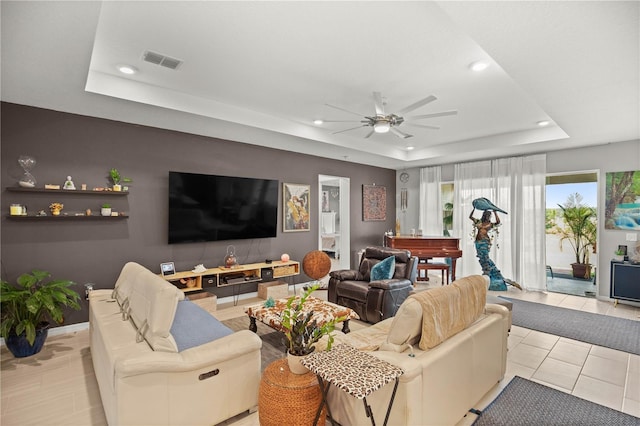 living area featuring a tray ceiling, visible vents, a ceiling fan, and recessed lighting