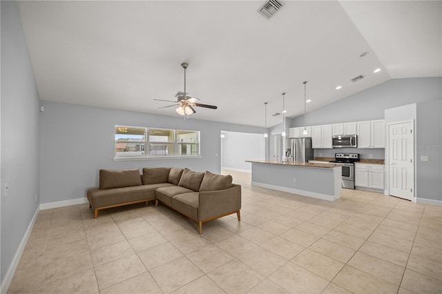 living room with light tile patterned floors, vaulted ceiling, a ceiling fan, and visible vents