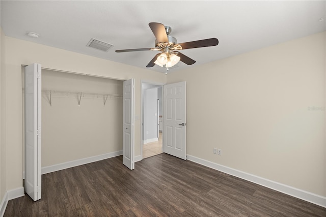 unfurnished bedroom featuring visible vents, baseboards, a closet, ceiling fan, and dark wood-type flooring