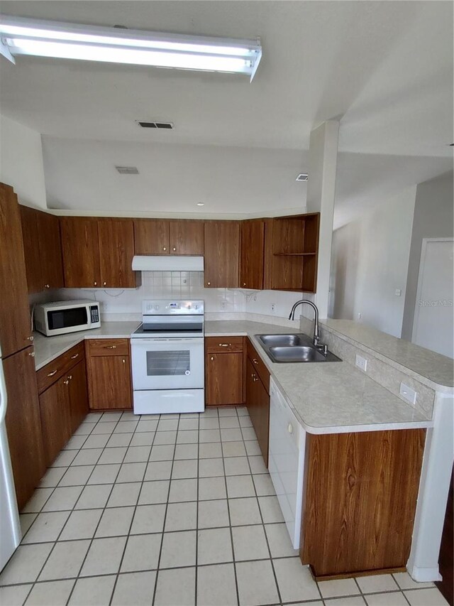 10315 SW 62nd Terrace Rd, Ocala, FL 34476 - kitchen featuring white appliances, a sink, under cabinet range hood, open shelves, and light countertops