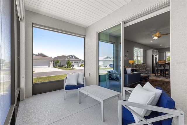 sunroom featuring a ceiling fan