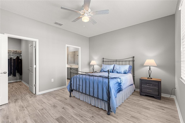 bedroom featuring baseboards, wood finished floors, and visible vents