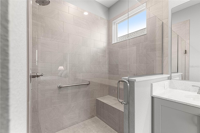 bathroom featuring vanity and a shower stall