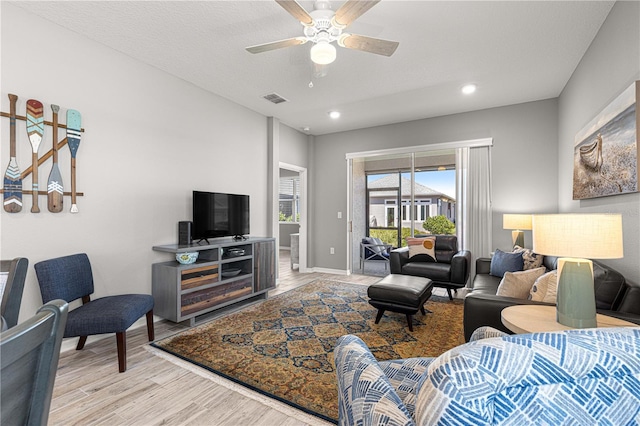 living room with ceiling fan, light wood finished floors, baseboards, visible vents, and recessed lighting