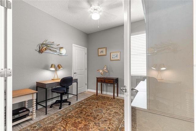 office area with baseboards, a ceiling fan, french doors, and wood finished floors