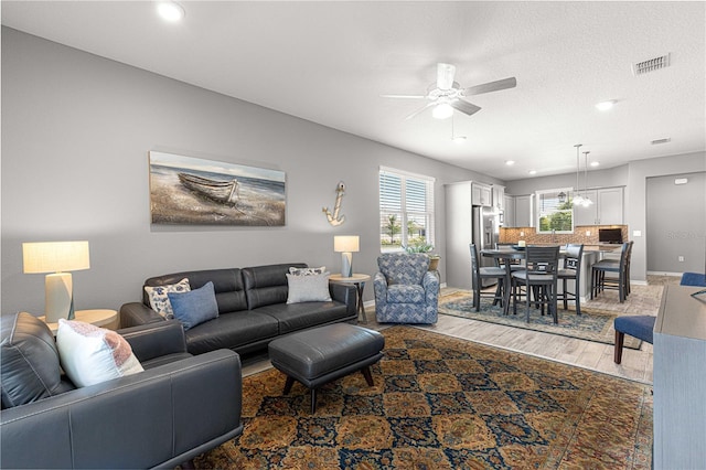 living area with recessed lighting, light wood-style floors, visible vents, and ceiling fan