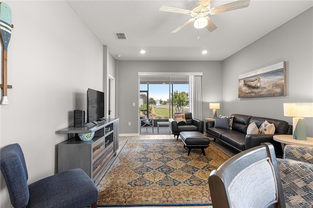 living room featuring baseboards, a ceiling fan, visible vents, and recessed lighting