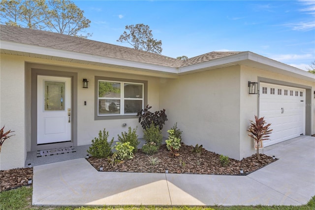 77 Locust Dr, Ocala, FL 34472 - property entrance with roof with shingles, concrete driveway, a garage, and stucco siding