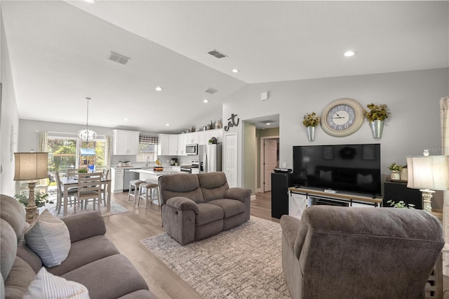 77 Locust Dr, Ocala, FL 34472 - living room featuring light wood-style floors, vaulted ceiling, visible vents, and recessed lighting