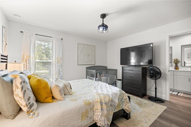 77 Locust Dr, Ocala, FL 34472 - bedroom with connected bathroom, wood finished floors, and baseboards