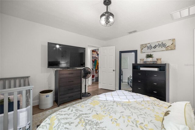77 Locust Dr, Ocala, FL 34472 - bedroom featuring baseboards, dark wood-type flooring, visible vents, and a walk in closet