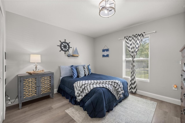 77 Locust Dr, Ocala, FL 34472 - bedroom with baseboards and wood finished floors