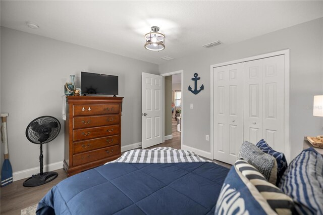 77 Locust Dr, Ocala, FL 34472 - bedroom with baseboards, wood finished floors, and a closet