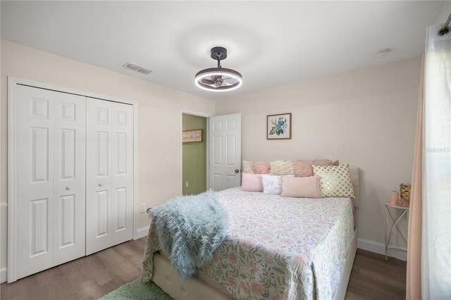 77 Locust Dr, Ocala, FL 34472 - bedroom featuring wood finished floors, a closet, and baseboards