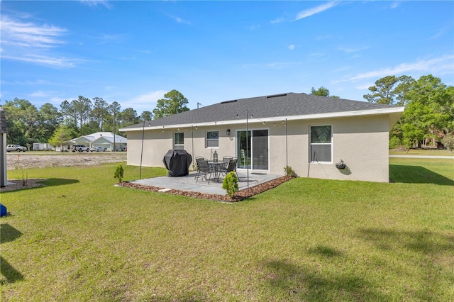 77 Locust Dr, Ocala, FL 34472 - rear view of property featuring a patio, roof with shingles, stucco siding, and a lawn