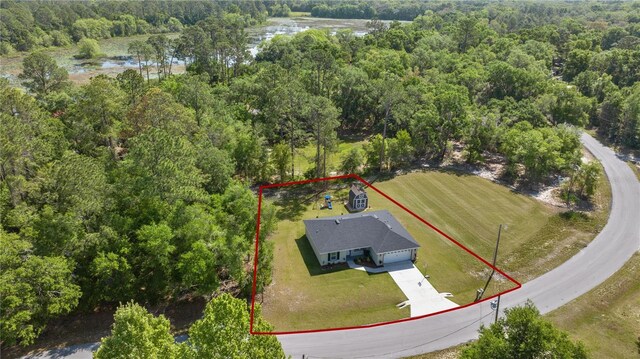 77 Locust Dr, Ocala, FL 34472 - aerial view of property's location featuring a heavily wooded area, property boundaries highlighted, and a nearby body of water