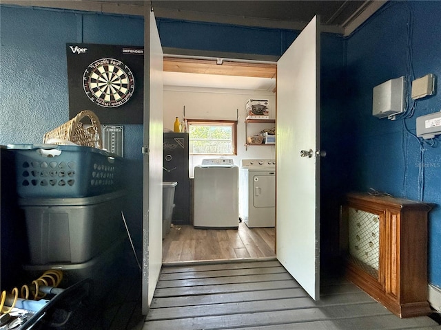 laundry area with washer and clothes dryer, hardwood / wood-style flooring, and laundry area
