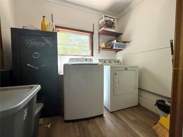 washroom featuring a sink, wood finished floors, separate washer and dryer, and laundry area