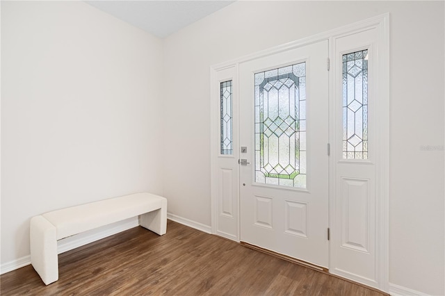 entryway featuring baseboards and wood finished floors