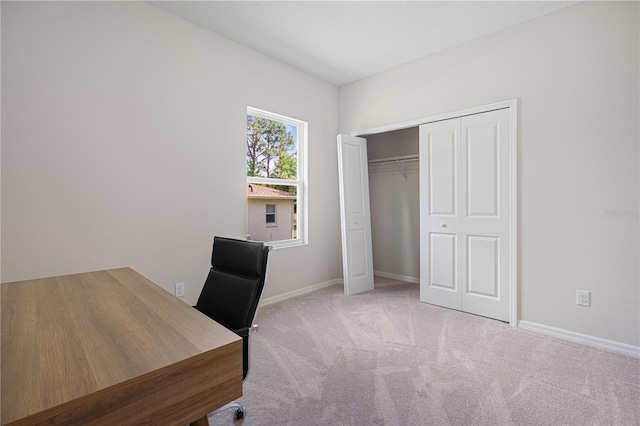 unfurnished office featuring carpet and baseboards