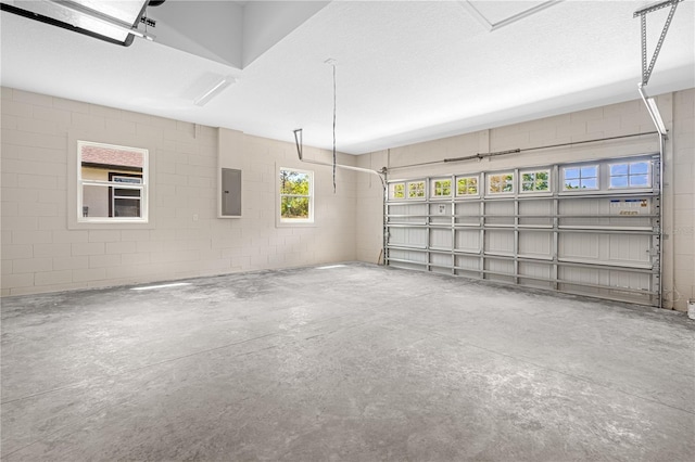 garage with electric panel and concrete block wall