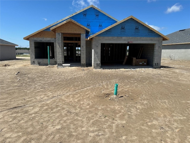 view of front of property featuring a garage and concrete block siding
