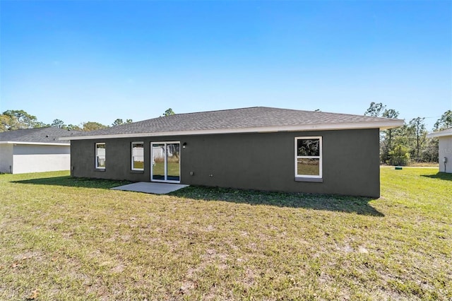 10374 SE 126th Ln, Belleview, FL 34420 - back of property with a lawn and stucco siding
