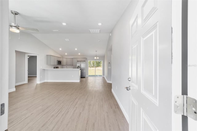 10374 SE 126th Ln, Belleview, FL 34420 - unfurnished living room with a ceiling fan, vaulted ceiling, baseboards, recessed lighting, and light wood-style flooring