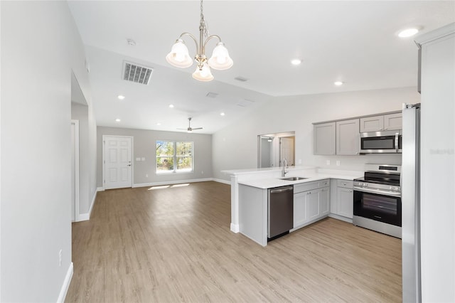 10374 SE 126th Ln, Belleview, FL 34420 - kitchen featuring visible vents, lofted ceiling, a sink, gray cabinetry, and stainless steel appliances