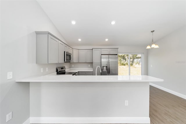 10374 SE 126th Ln, Belleview, FL 34420 - kitchen with gray cabinets, light countertops, baseboards, a peninsula, and stainless steel appliances