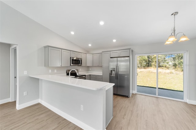 10374 SE 126th Ln, Belleview, FL 34420 - kitchen with light countertops, gray cabinets, stainless steel appliances, a peninsula, and light wood-type flooring