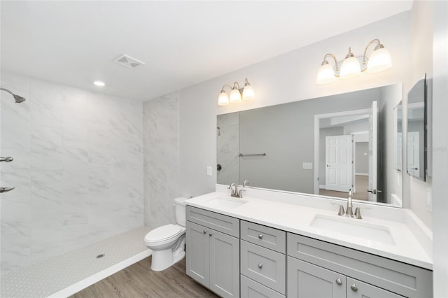 10374 SE 126th Ln, Belleview, FL 34420 - full bathroom featuring double vanity, toilet, a tile shower, and a sink