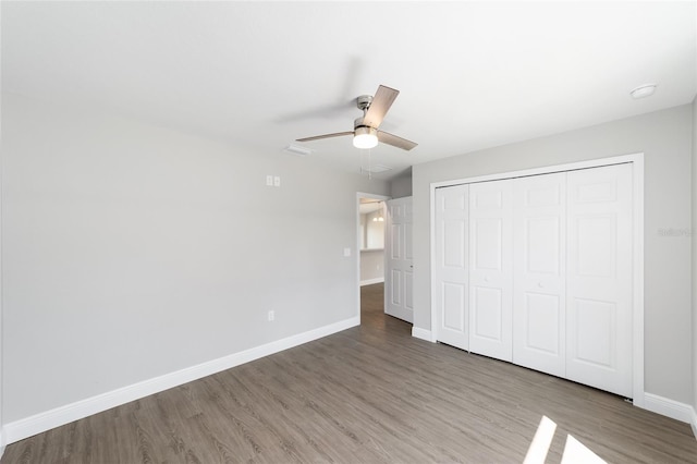 10374 SE 126th Ln, Belleview, FL 34420 - unfurnished bedroom with baseboards, ceiling fan, wood finished floors, and a closet