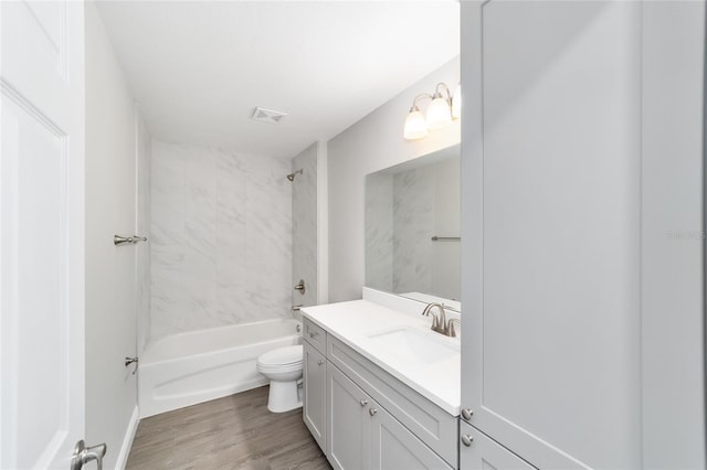 10374 SE 126th Ln, Belleview, FL 34420 - full bathroom with vanity, toilet, tub / shower combination, wood finished floors, and visible vents