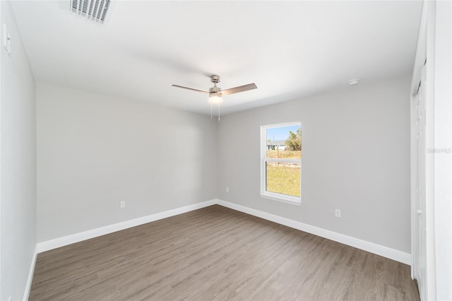 10374 SE 126th Ln, Belleview, FL 34420 - spare room featuring baseboards, a ceiling fan, wood finished floors, and visible vents