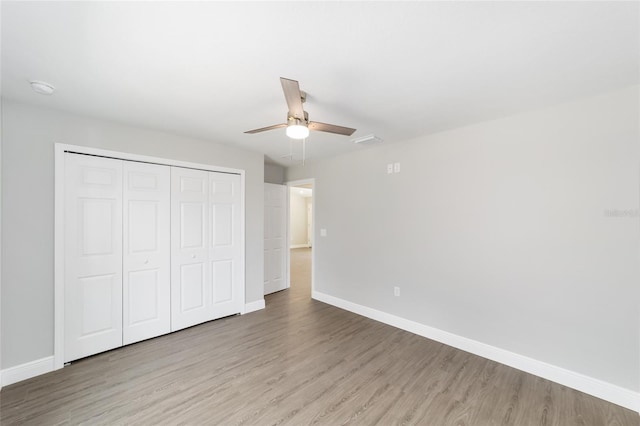 10374 SE 126th Ln, Belleview, FL 34420 - unfurnished bedroom with baseboards and wood finished floors